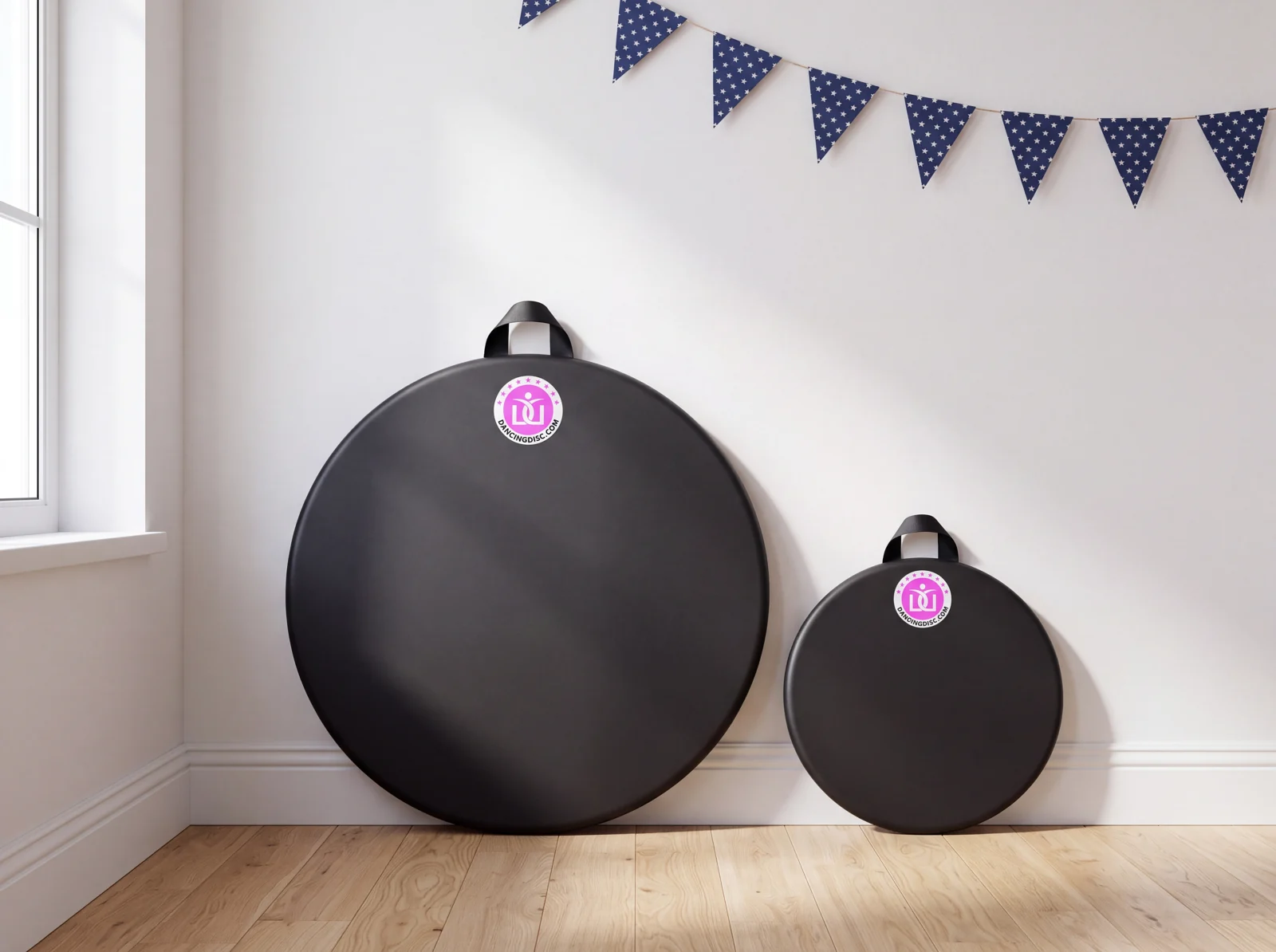 Two Dancing Disc practice boards, 30 and 16 inches, leaning against a wall under Labor Day bunting